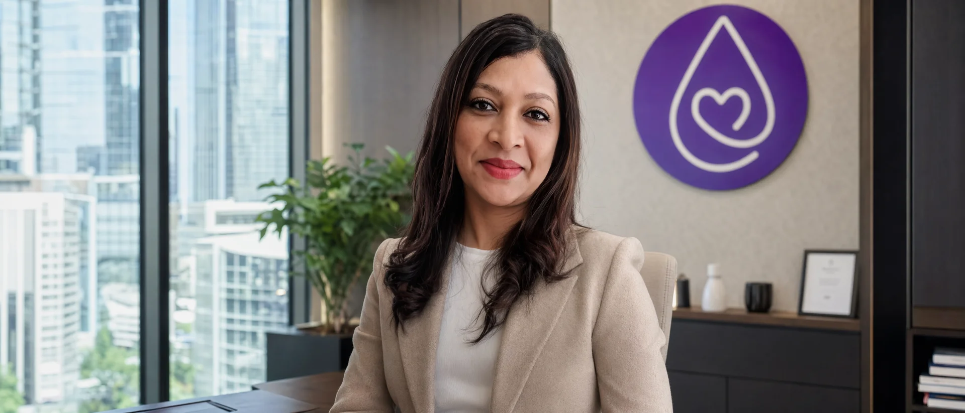 Karen Naidoo, National Operations Director, at her desk in The Well Team's Sydney office